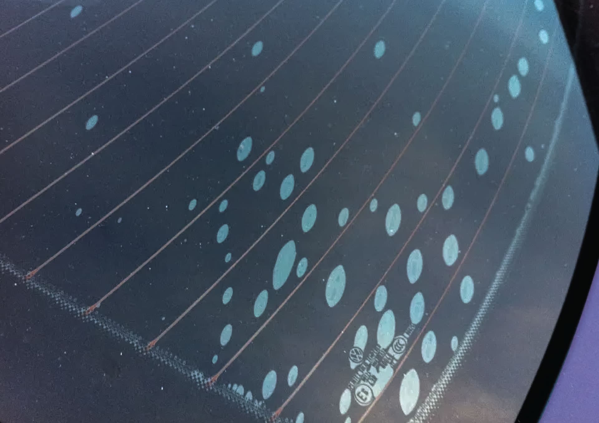 Window tint showing bubbling and lifting defects from a bad install