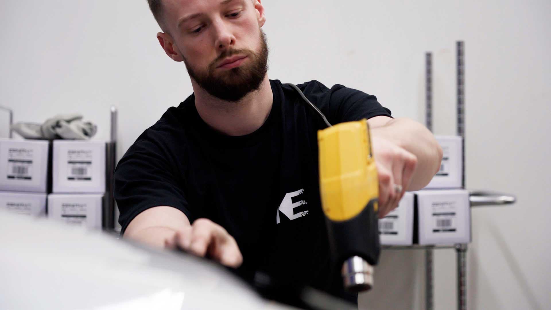 Kepler window tinting installer focused on a clean film install